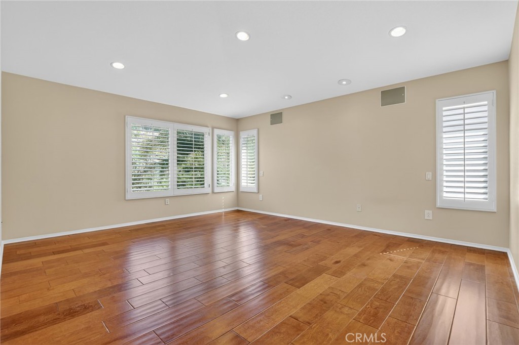 20543 Pesaro Porter Ranch Porter Ranch, CA 91326 - Photo 32 of 67 a view of an empty room with wooden floor and a window
