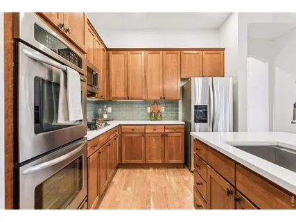 a kitchen with a refrigerator a sink and cabinets