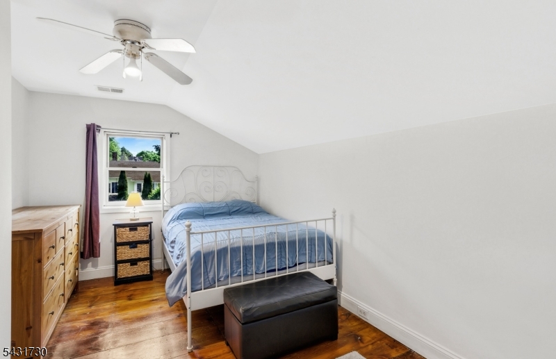 105 Main Street Lebanon, NJ 08833 - Photo 17 of 25 a bedroom with a bed and a chandelier