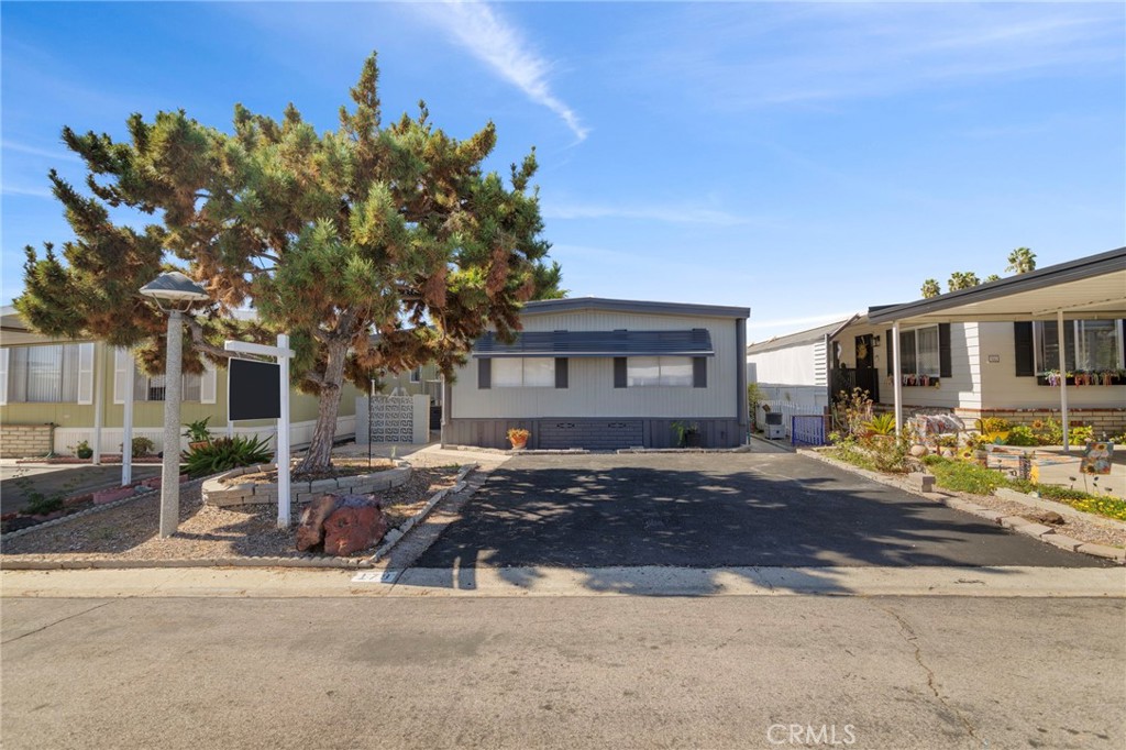 1001 West Lambert Road, Unit 179 La Habra, CA 90631 - Photo 1 of 27 a row of palm trees in front of a building
