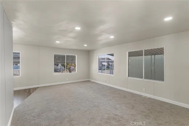 an empty room with windows and closet