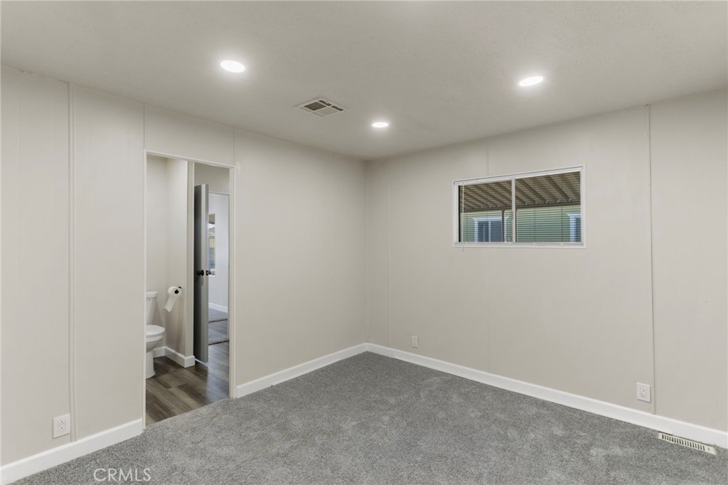 1001 West Lambert Road, Unit 179 La Habra, CA 90631 - Photo 17 of 27 an empty room with a gallery and a mirror