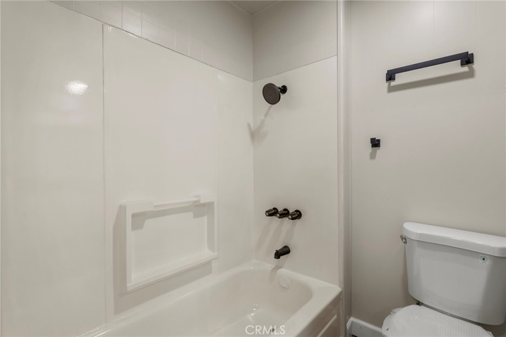 1001 West Lambert Road, Unit 179 La Habra, CA 90631 - Photo 22 of 27 a bathroom with a granite countertop bathtub shower and toilet