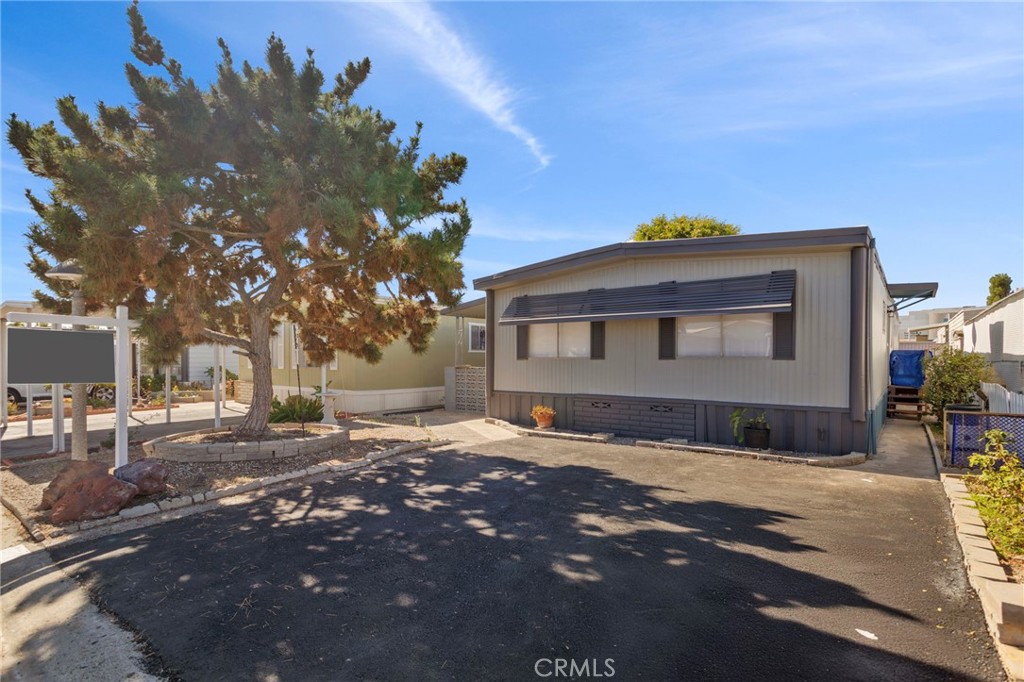 1001 West Lambert Road, Unit 179 La Habra, CA 90631 - Photo 3 of 27 a front view of a house with a yard