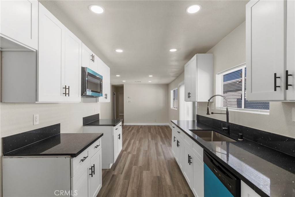 1001 West Lambert Road, Unit 179 La Habra, CA 90631 - Photo 4 of 27 a large kitchen with granite countertop a large counter top space a sink stainless steel appliances and cabinets