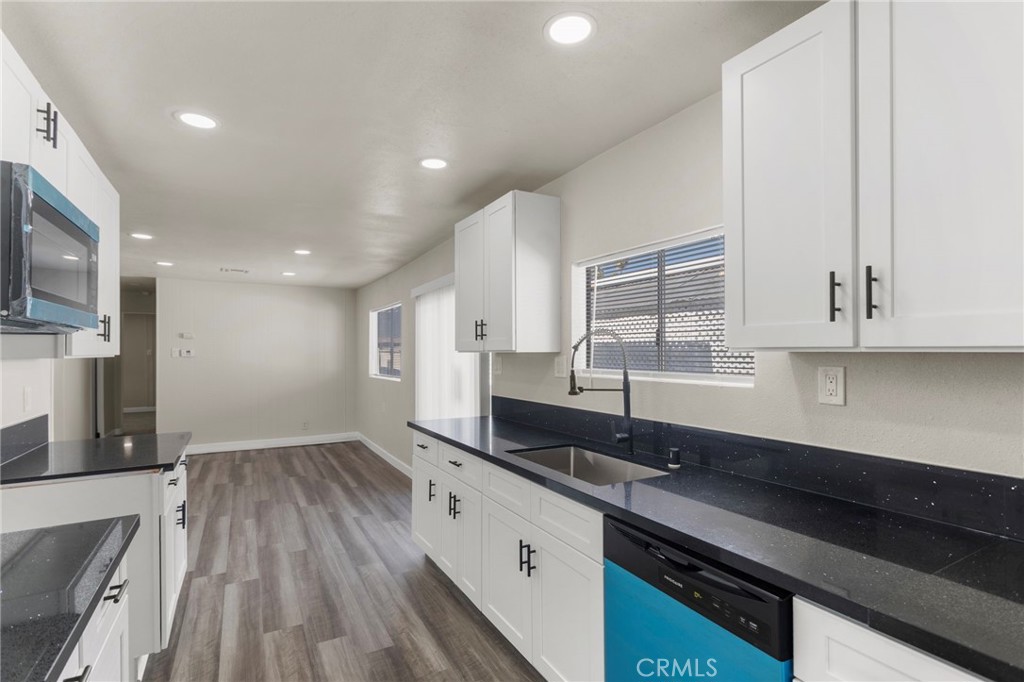 1001 West Lambert Road, Unit 179 La Habra, CA 90631 - Photo 6 of 27 a large kitchen with stainless steel appliances a large counter top a stove and a sink