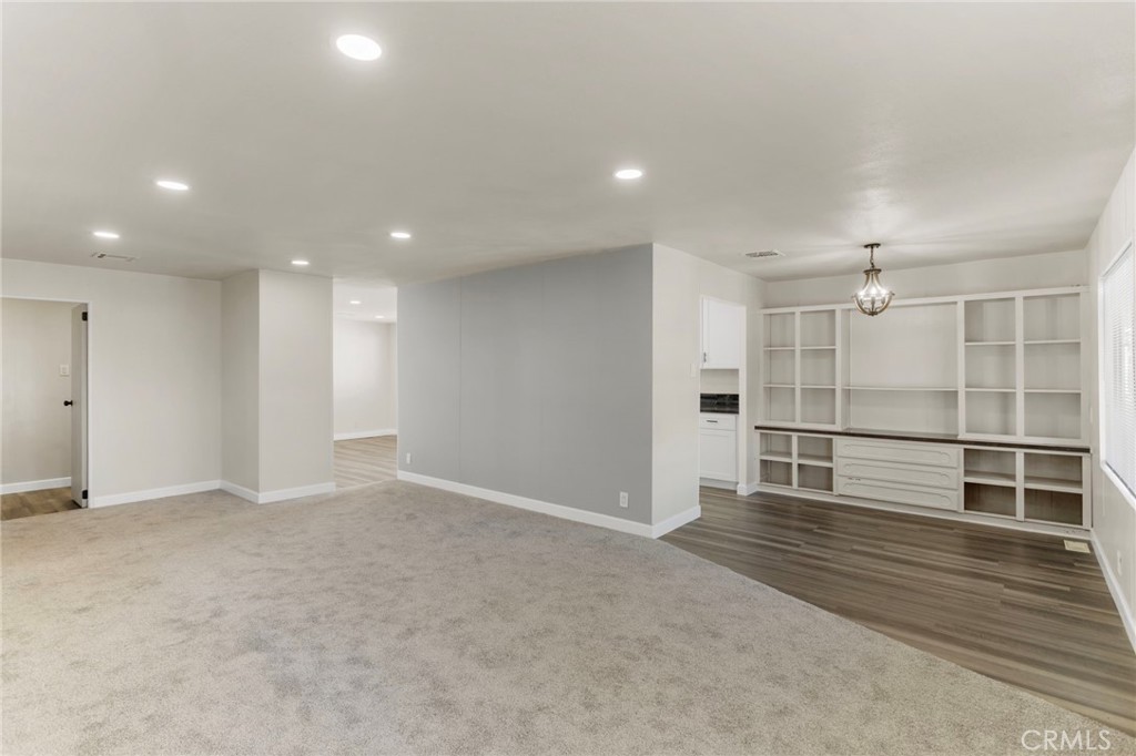 1001 West Lambert Road, Unit 179 La Habra, CA 90631 - Photo 7 of 27 an empty room with wooden floor and windows