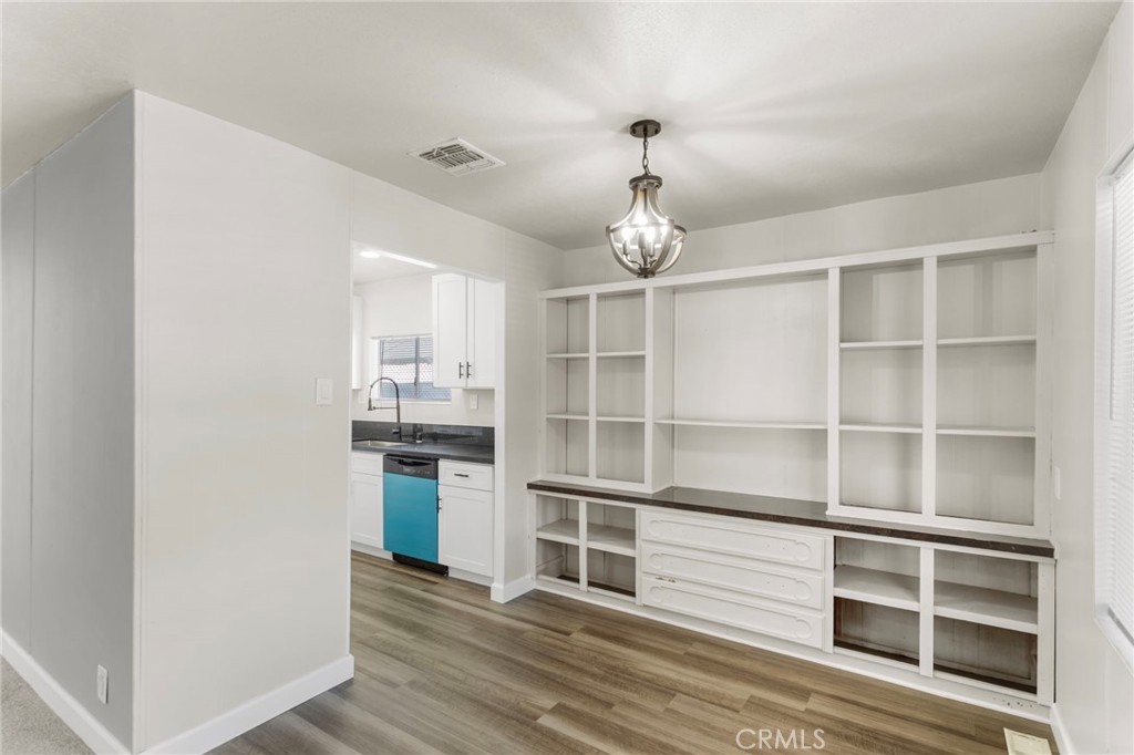1001 West Lambert Road, Unit 179 La Habra, CA 90631 - Photo 8 of 27 a view of a kitchen an empty room and wooden floor