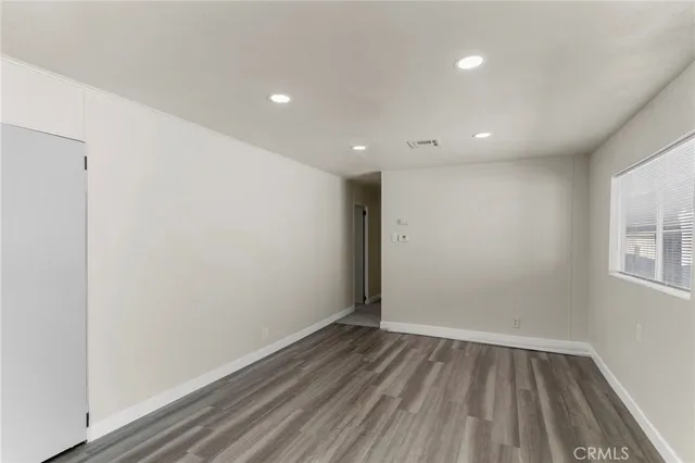 a view of room with window and wooden floor