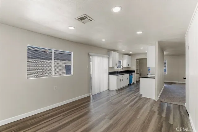 a kitchen with a refrigerator and a sink