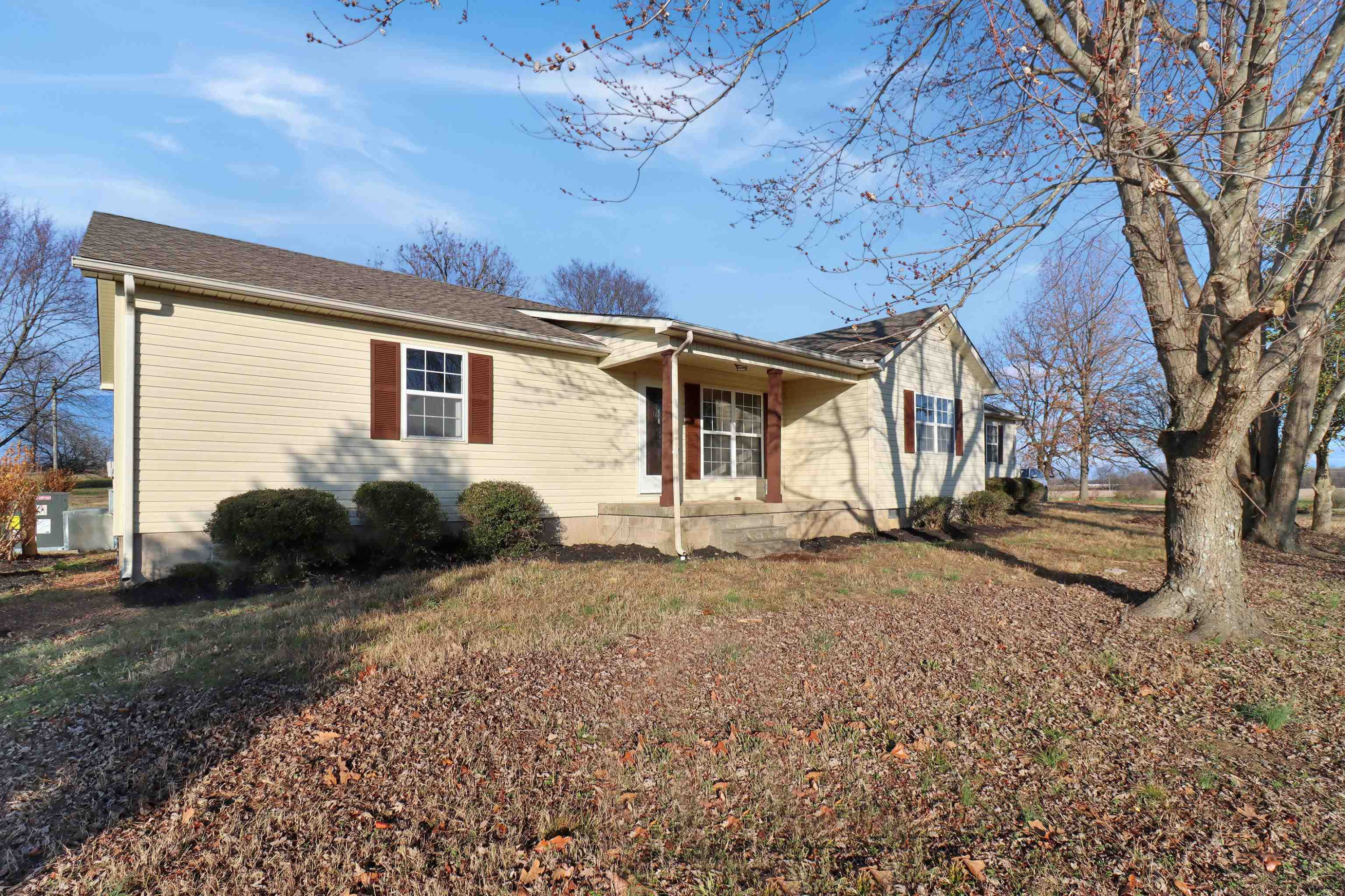 a view of a house with a yard and garage