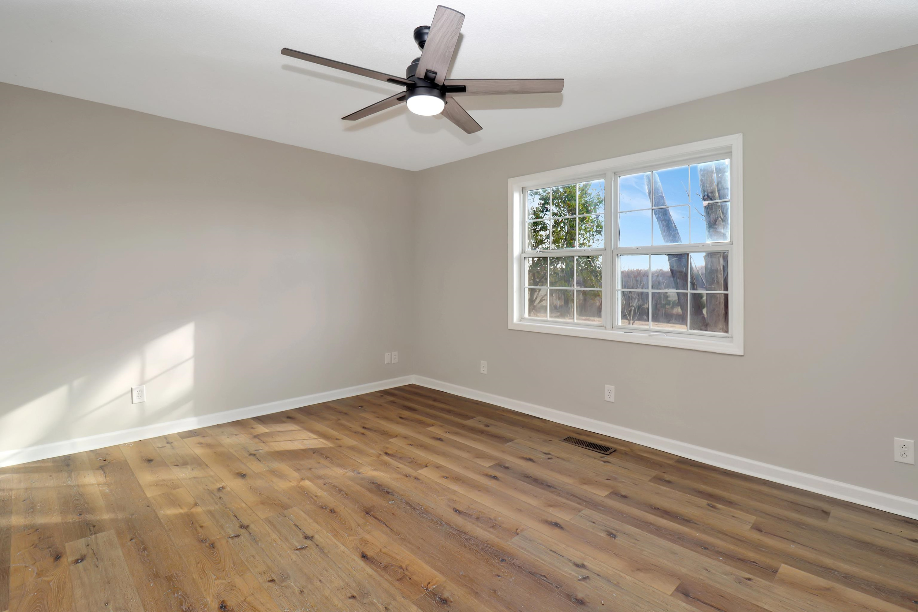 1810 OLd State Rte 76 McKenzie, TN 38201 - Photo 13 of 23 a view of an empty room with wooden floor and a window