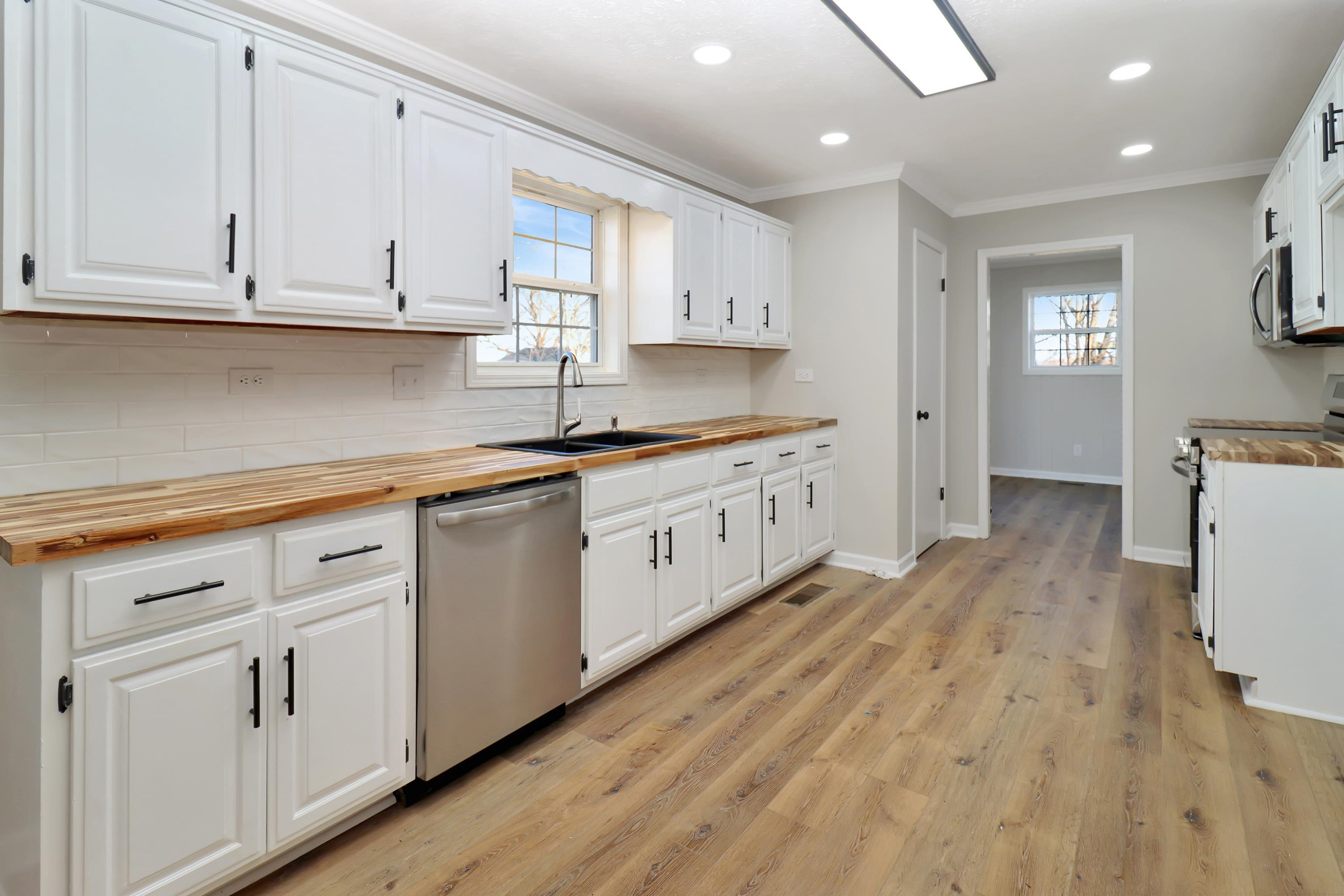 1810 OLd State Rte 76 McKenzie, TN 38201 - Photo 3 of 23 a kitchen with white cabinets and sink