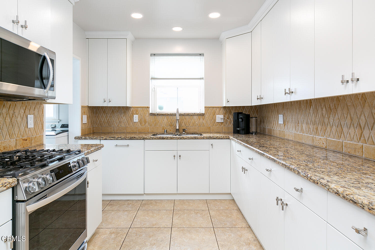 Undisclosed Address Altadena, CA 91001 - Photo 11 of 47 a kitchen with granite countertop a sink a stove top oven and white cabinets