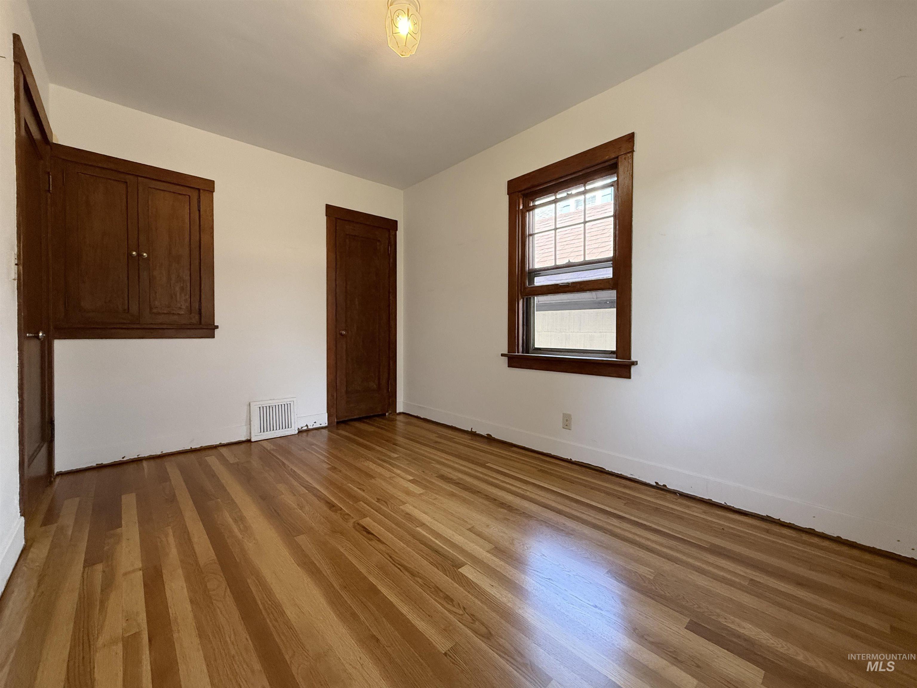 504 South Hayes Street Moscow, ID 83843 - Photo 15 of 44 Empty room featuring wood finished floors and baseboards