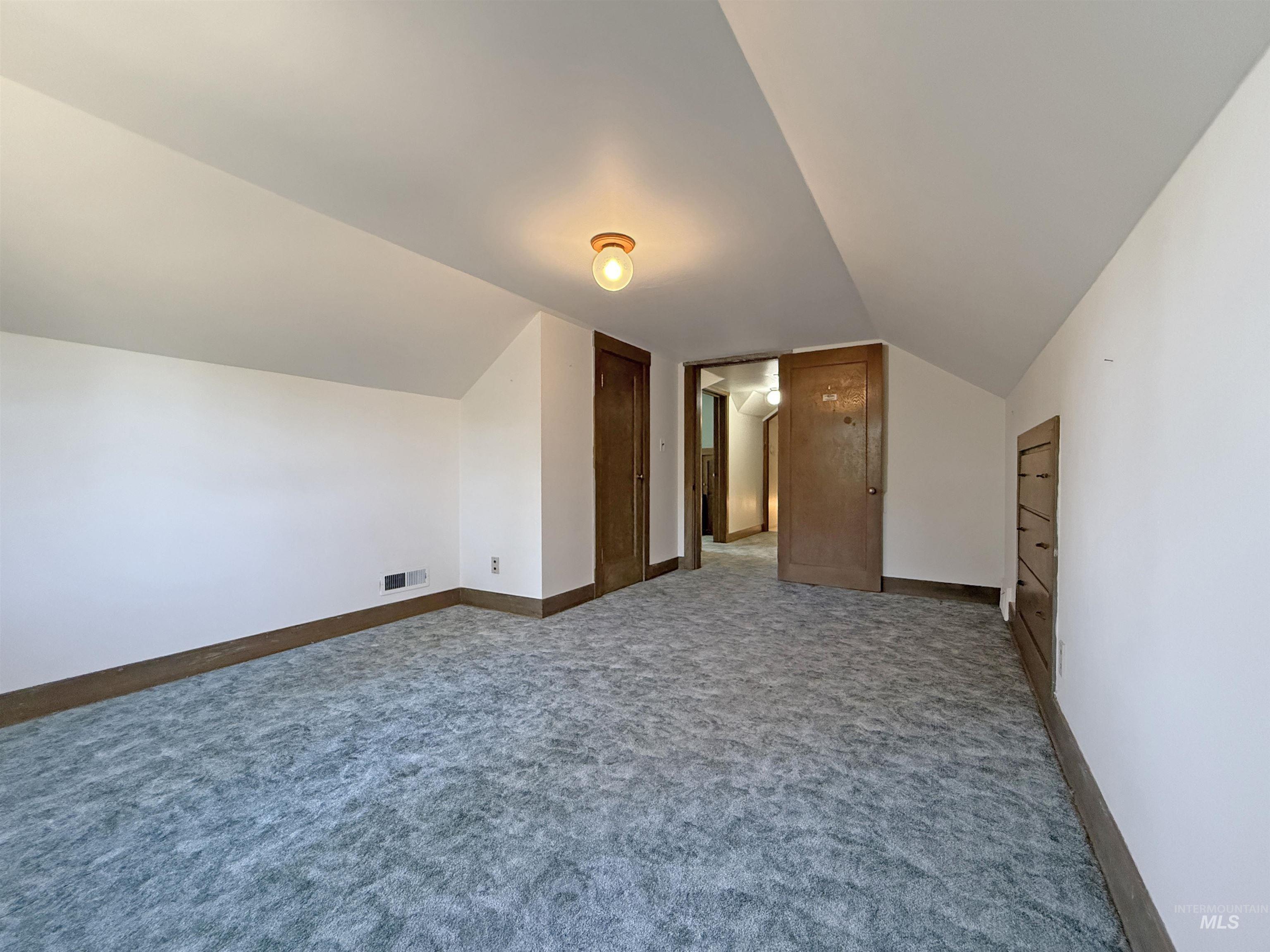 504 South Hayes Street Moscow, ID 83843 - Photo 26 of 44 Additional living space with carpet floors and vaulted ceiling