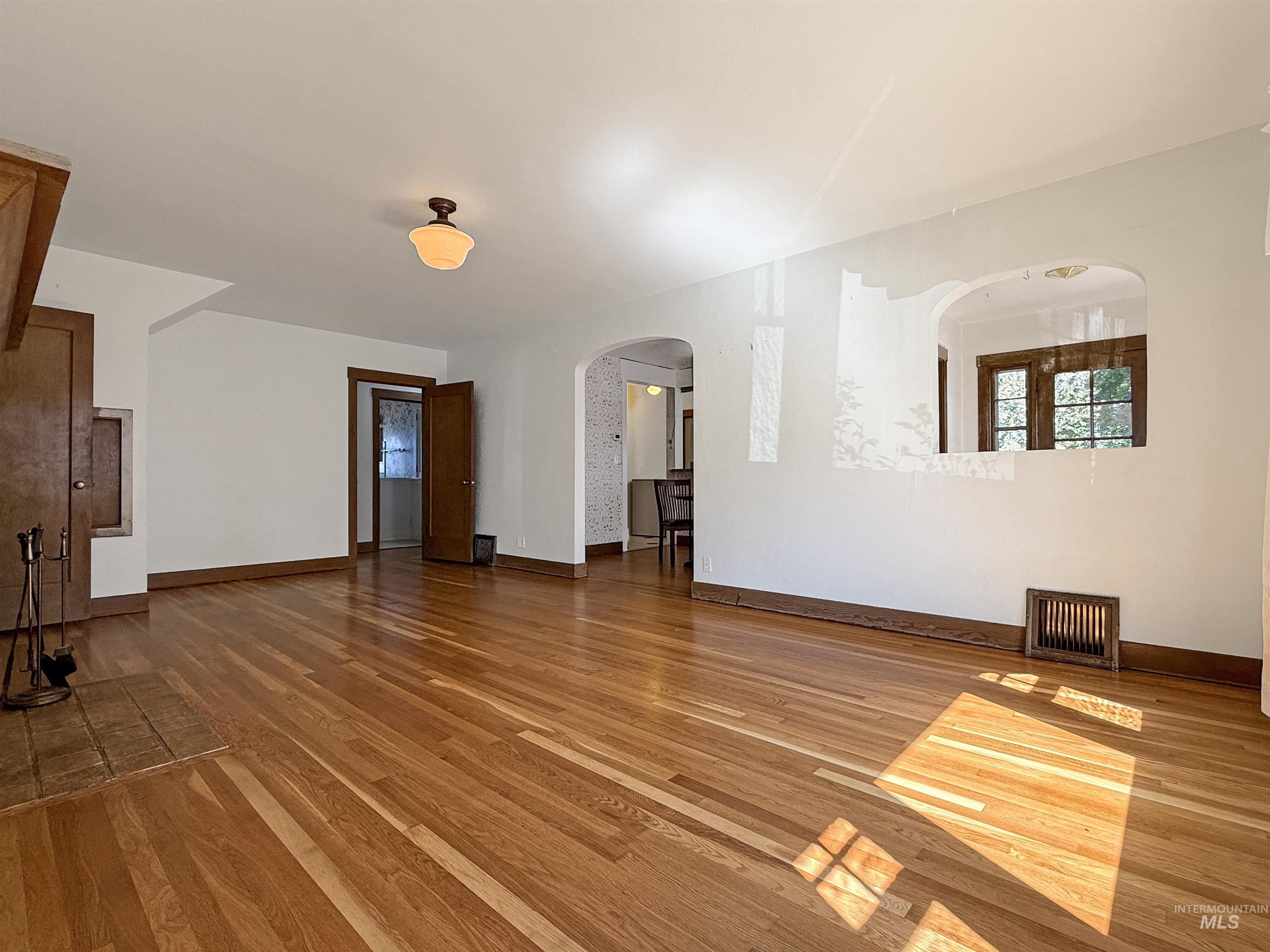 504 South Hayes Street Moscow, ID 83843 - Photo 5 of 44 Unfurnished living room with light wood finished floors and arched walkways