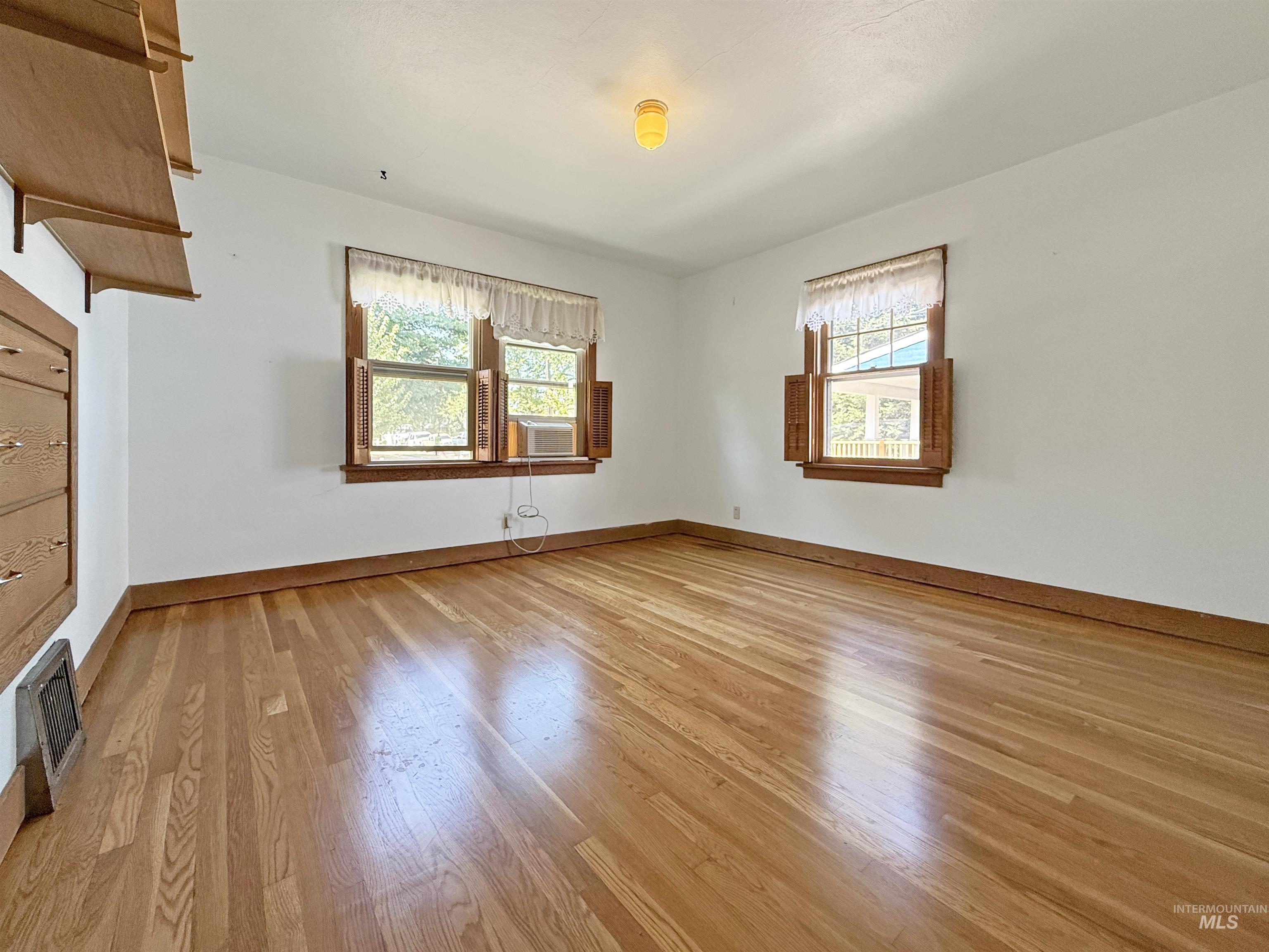 504 South Hayes Street Moscow, ID 83843 - Photo 8 of 44 Empty room with baseboards and light wood-style flooring