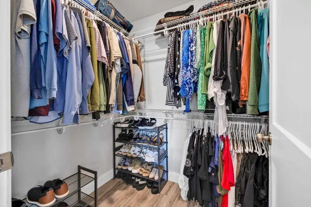 a view of walk in closet with clothes