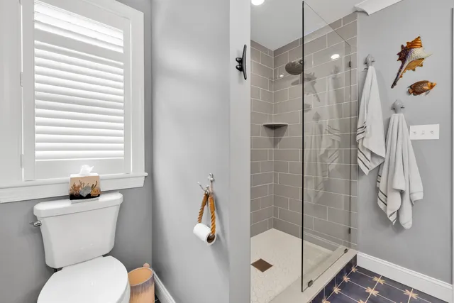 a bathroom with a toilet and shower