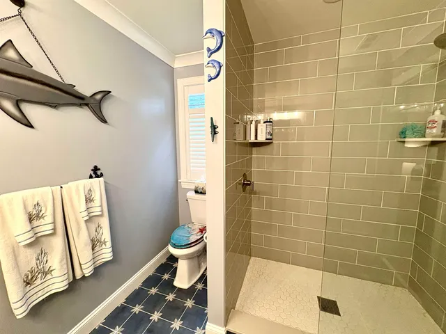 a bathroom with a toilet and shower