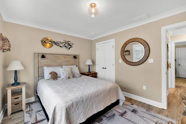 a bedroom with a bed and a lamp on dresser