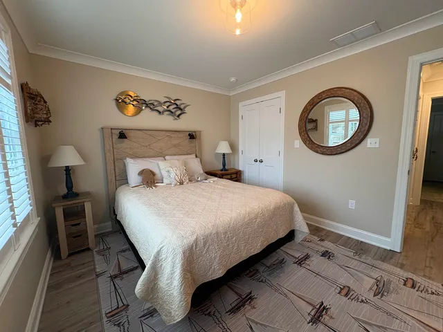 a bedroom with a bed and a lamp on dresser