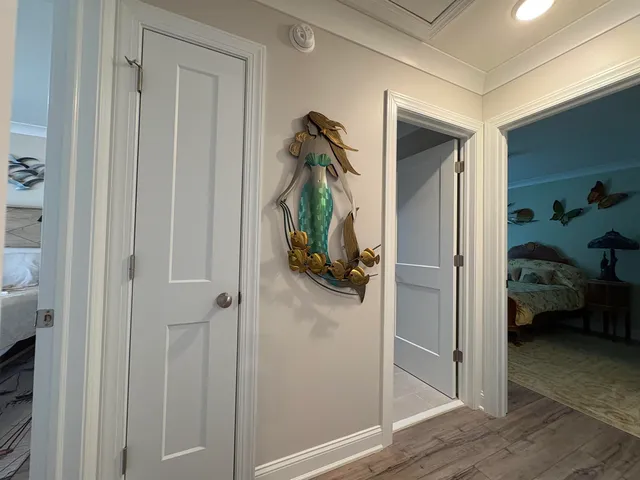 a view of a hallway with bedroom and wooden floor