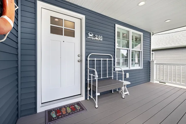 a view of front door with deck and a chair