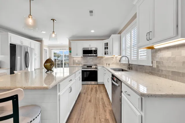 a kitchen with a table chairs stove and microwave