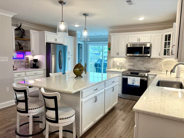 a kitchen with stainless steel appliances kitchen island granite countertop a sink and cabinets