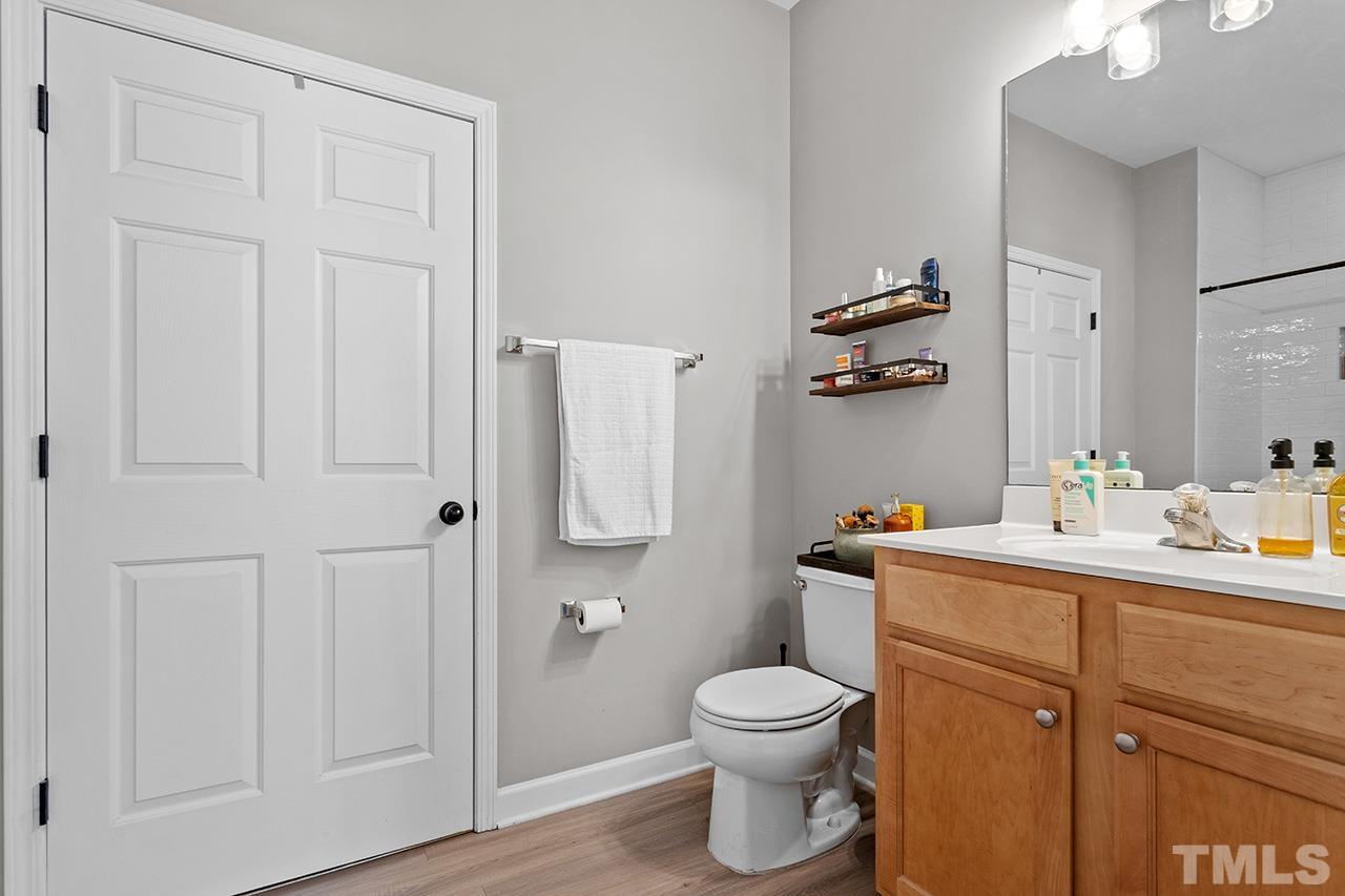 844 Horton Road, Unit 32 Durham, NC 27704 - Photo 14 of 17 a bathroom with a toilet sink vanity and mirror