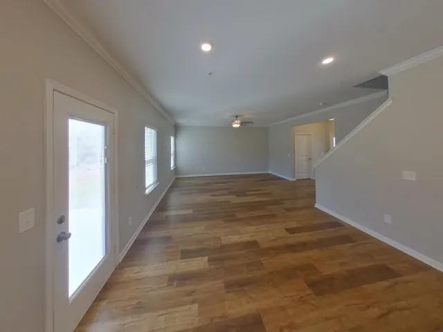 a view of an empty room with wooden floor