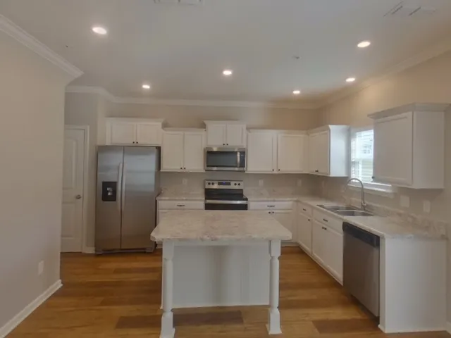 a kitchen with a sink stainless steel appliances and cabinets