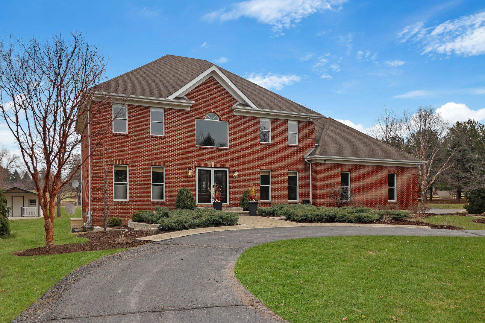a front view of house with yard and green space