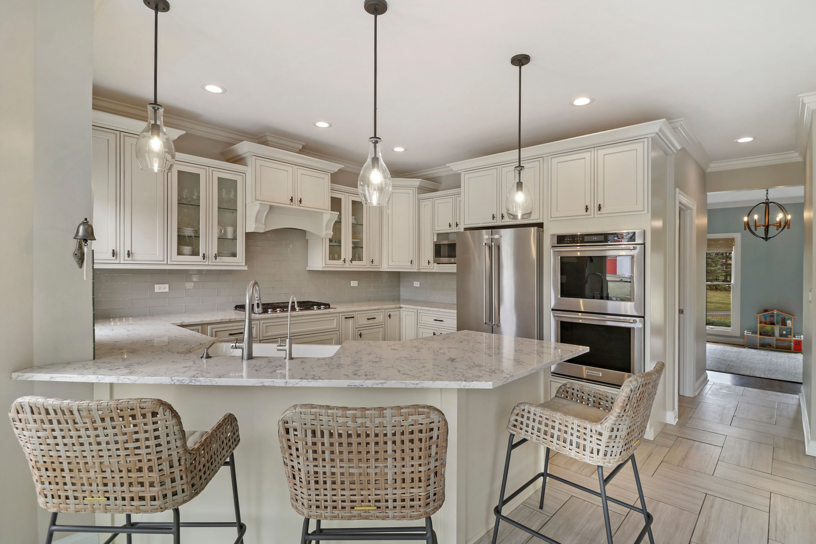 206 Spring Creek Road Barrington Hills, IL 60010 - Photo 11 of 56 a kitchen with stainless steel appliances granite countertop a sink a stove a refrigerator a kitchen island with a dining table and chairs