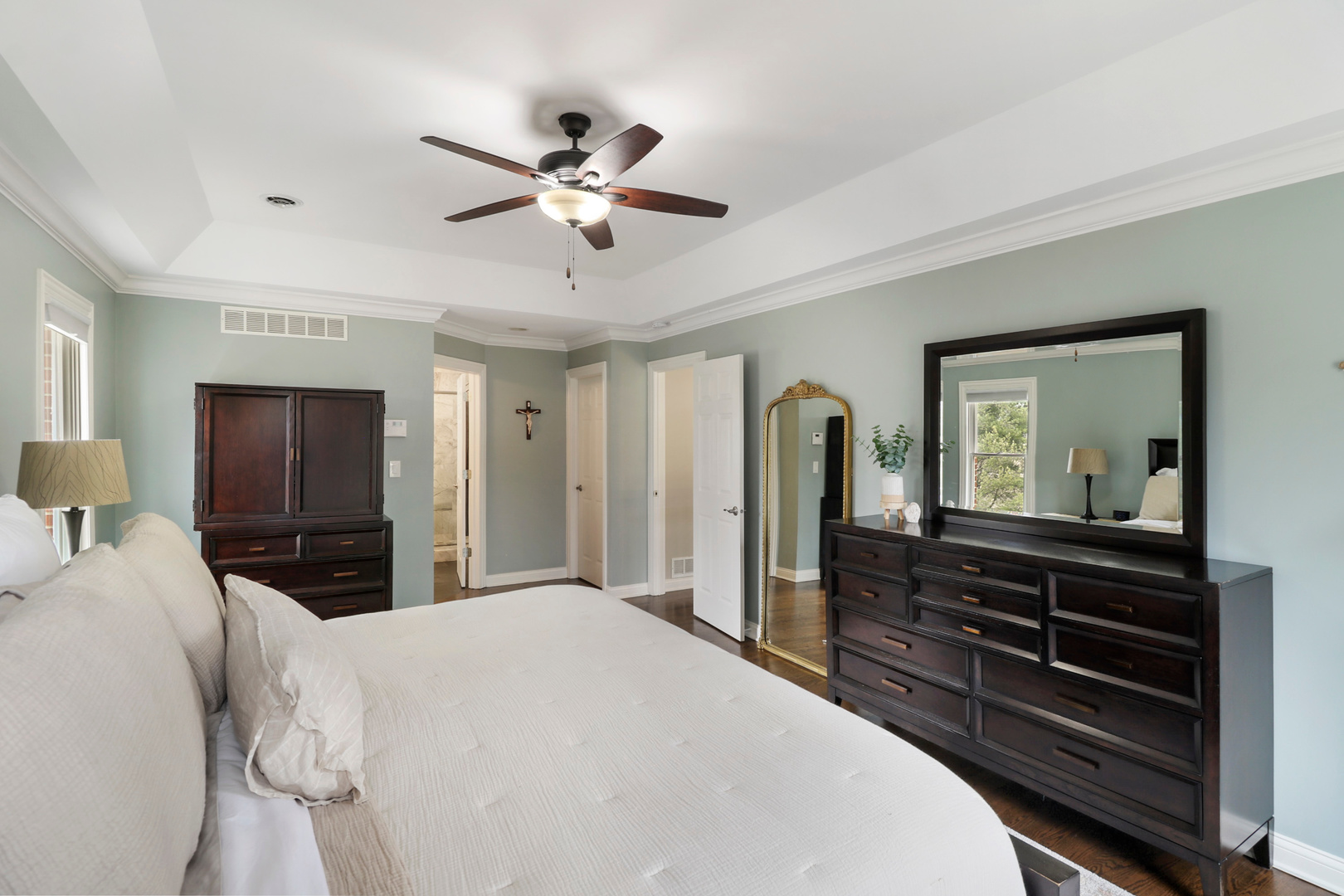 206 Spring Creek Road Barrington Hills, IL 60010 - Photo 18 of 56 a bedroom with a bed and a chandelier