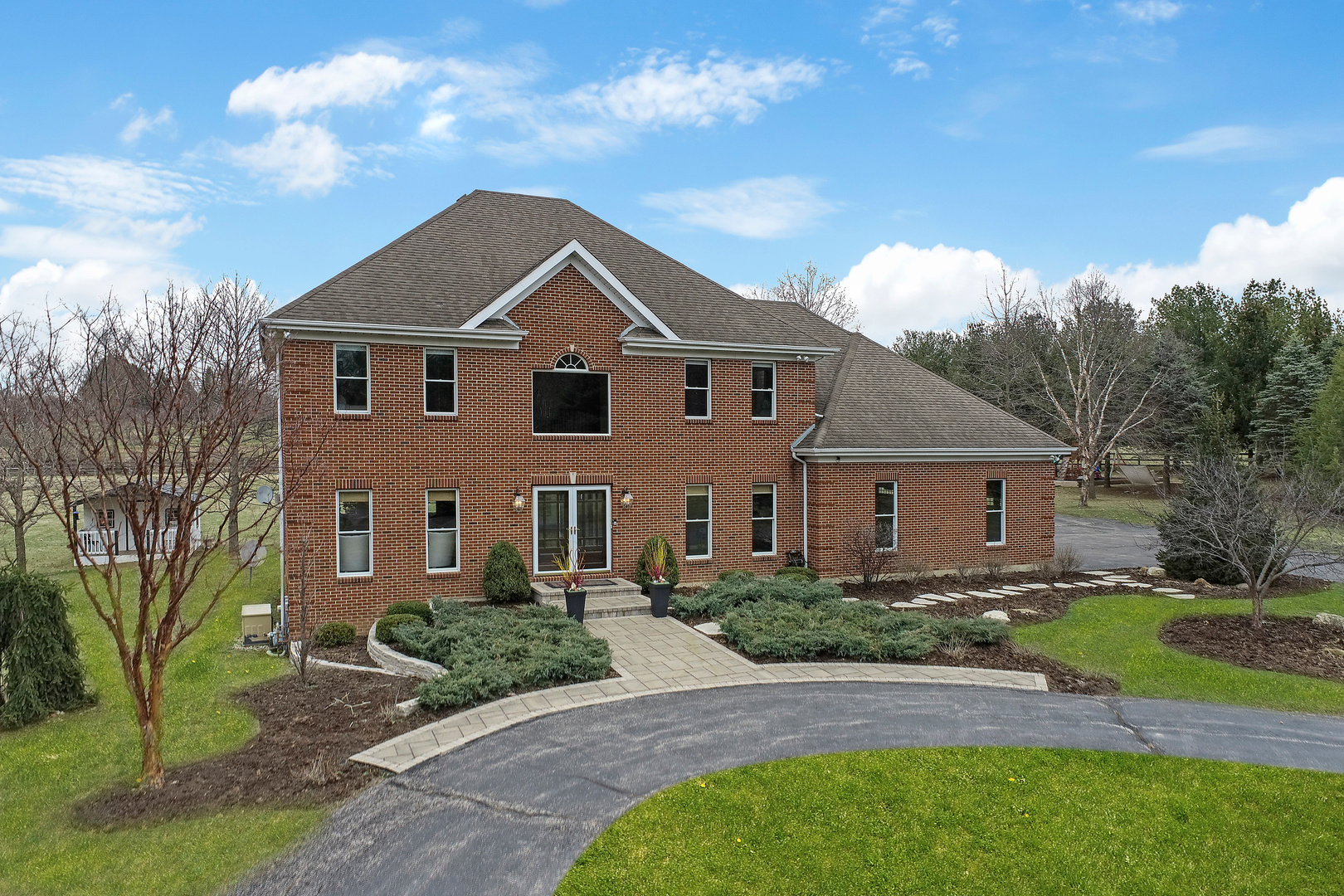 206 Spring Creek Road Barrington Hills, IL 60010 - Photo 38 of 56 a front view of a house with a yard
