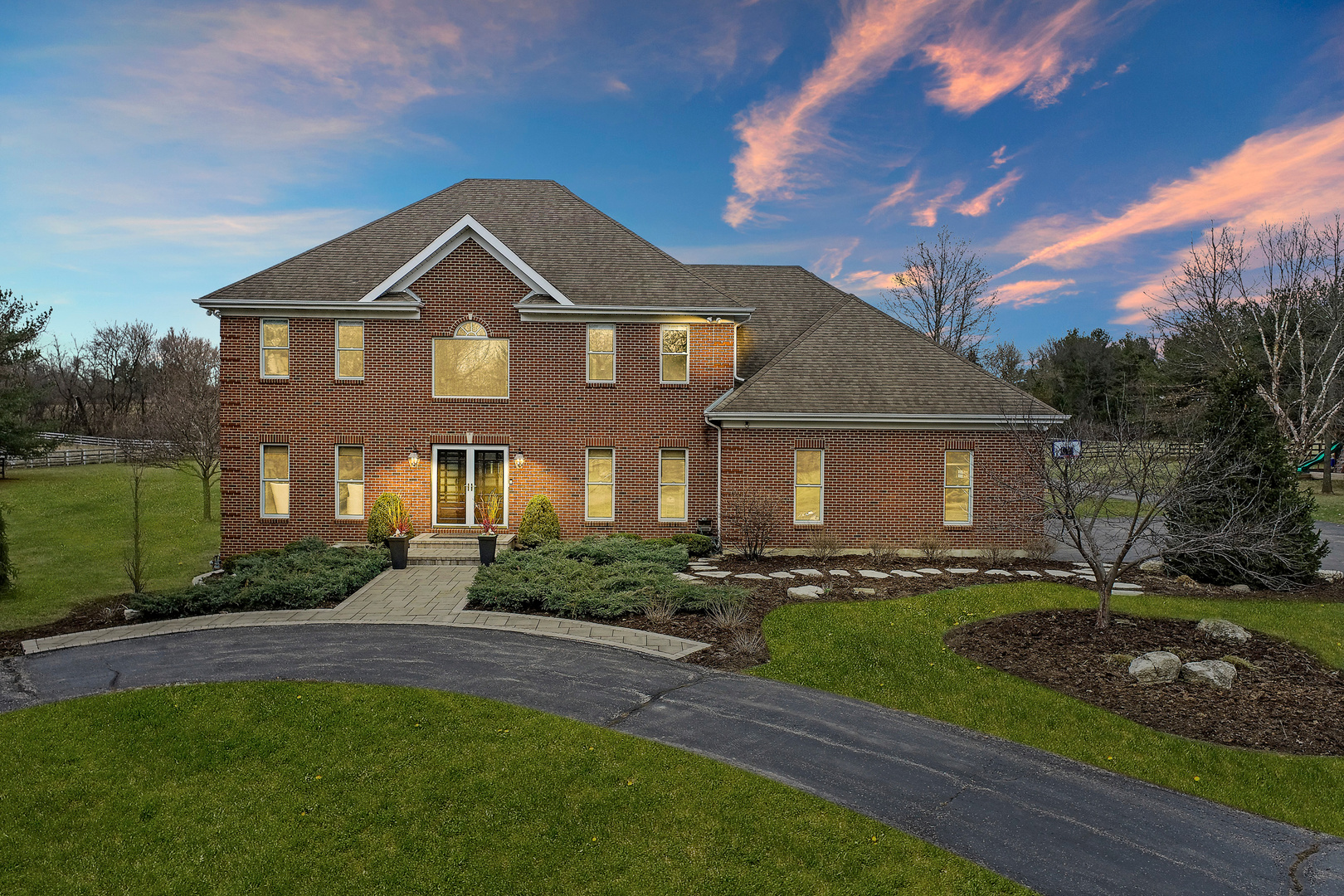 206 Spring Creek Road Barrington Hills, IL 60010 - Photo 40 of 56 a front view of a house with a yard