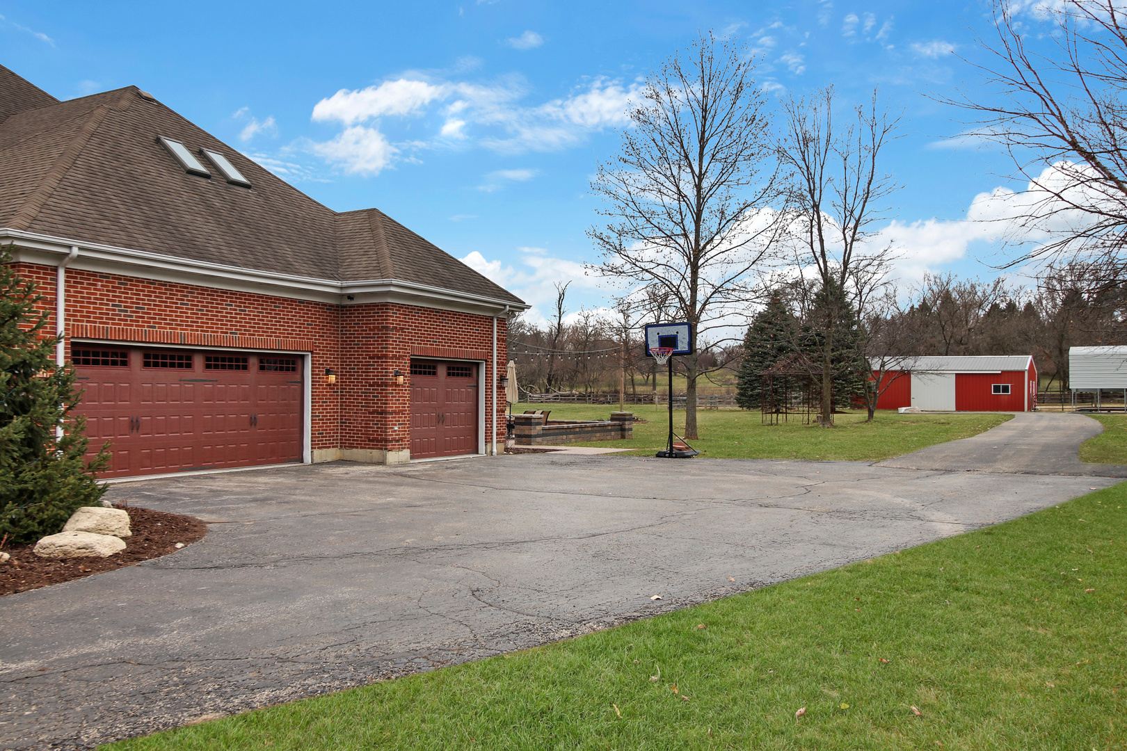206 Spring Creek Road Barrington Hills, IL 60010 - Photo 43 of 56 a front view of a house with a yard and garage