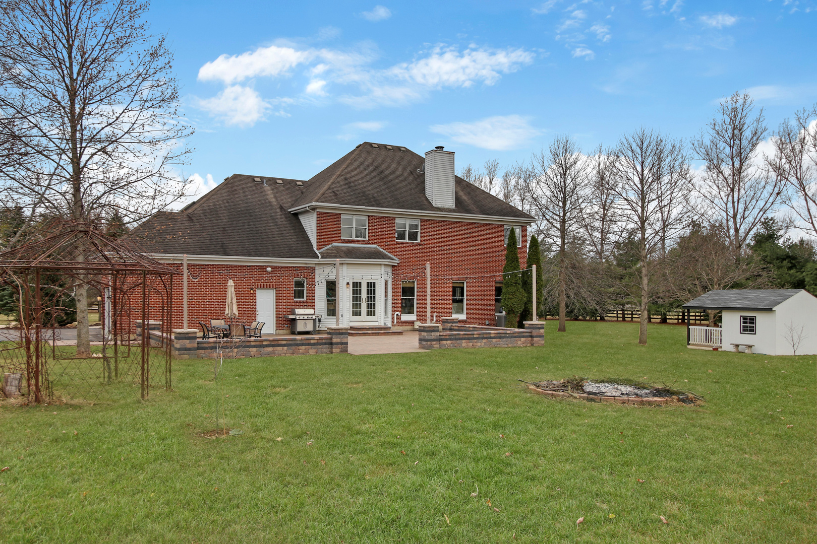 206 Spring Creek Road Barrington Hills, IL 60010 - Photo 48 of 56 a front view of house with a garden