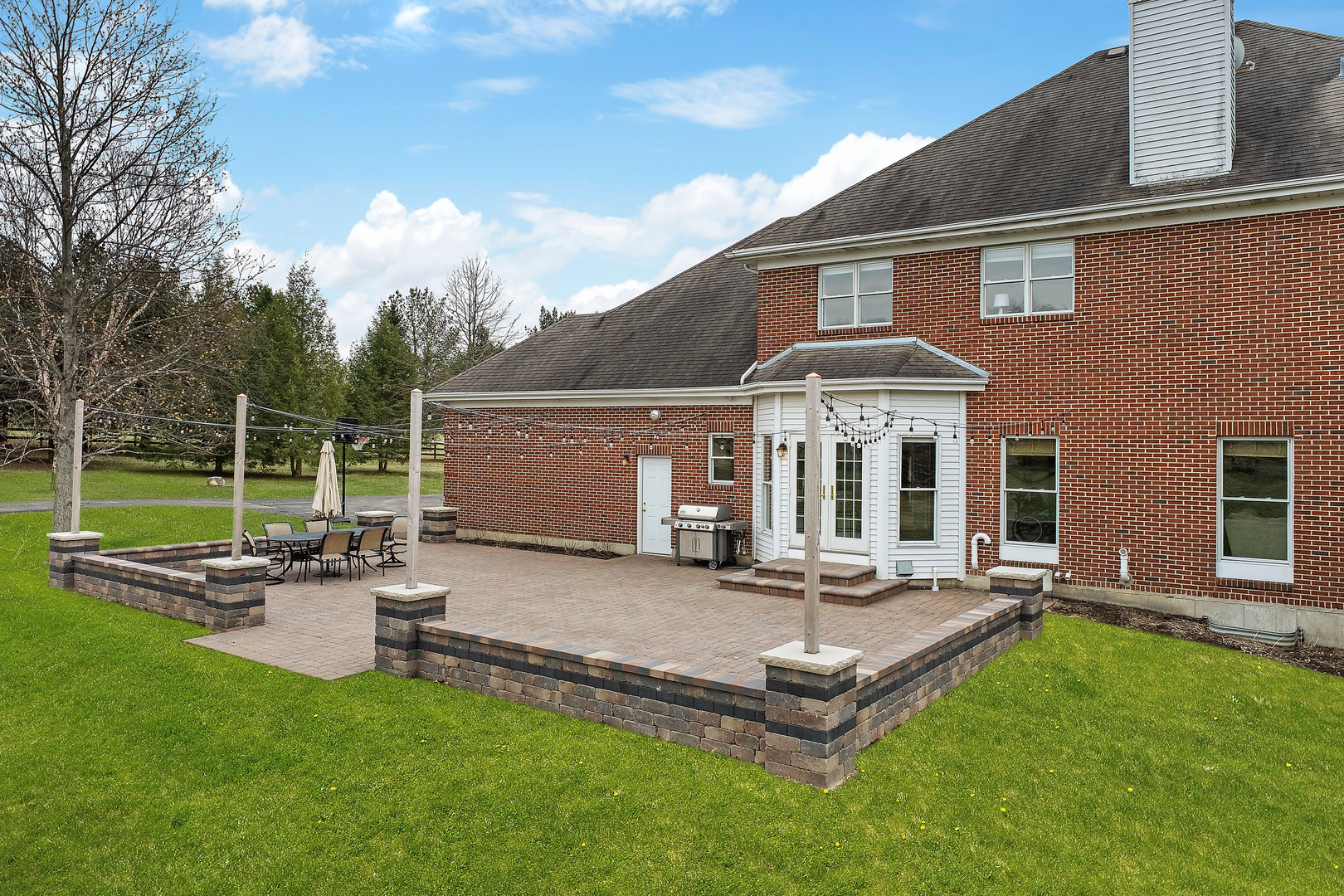 206 Spring Creek Road Barrington Hills, IL 60010 - Photo 50 of 56 a view of a house with backyard sitting area and garden