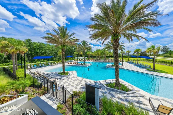 a view of swimming pool with a table and chairs