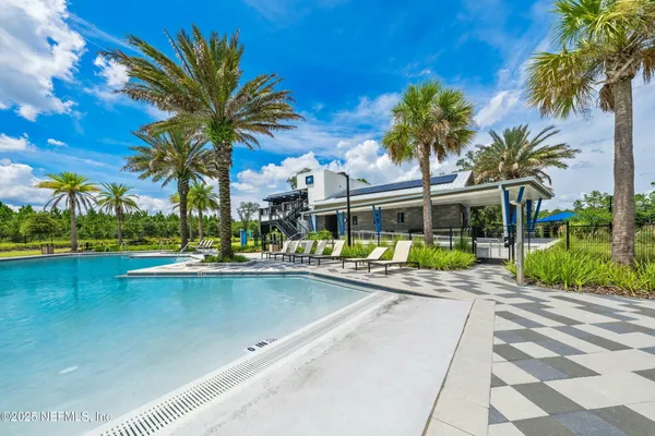 a view of swimming pool with a garden and trees