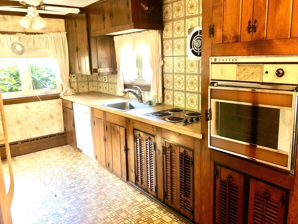 175 Maple Street Scituate, MA 02066 - Photo 3 of 9 a kitchen with stainless steel appliances a stove and a refrigerator