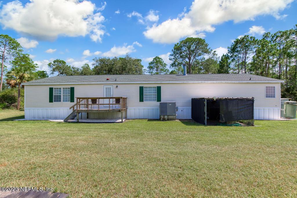565 Stokes Landing Road St. Augustine, FL 32095 - Photo 11 of 58 a view of a house with a yard and garage
