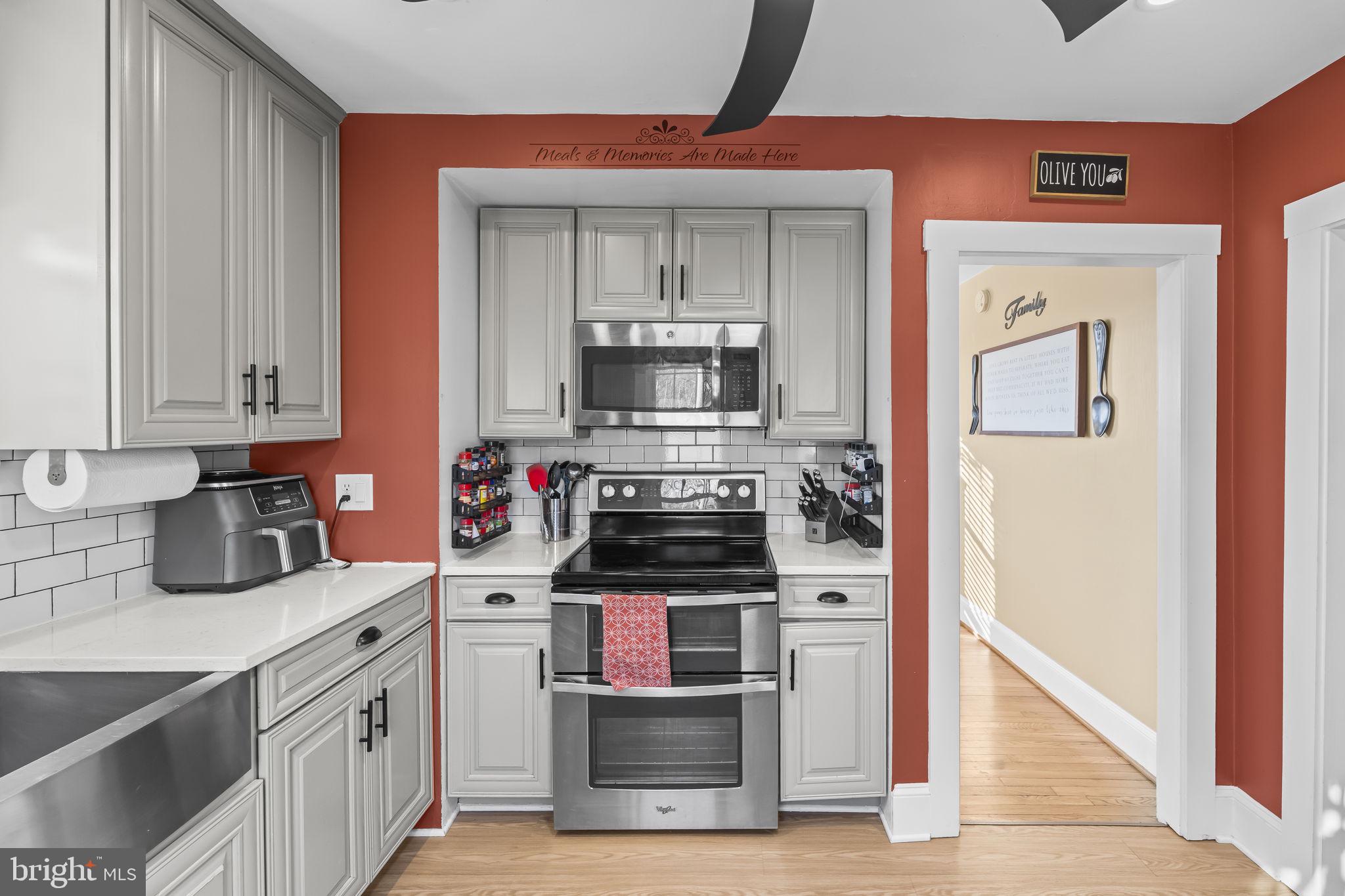 5920 Cherry Hill Road Huntingtown, MD 20639 - Photo 13 of 37 a kitchen with stainless steel appliances a stove and a refrigerator