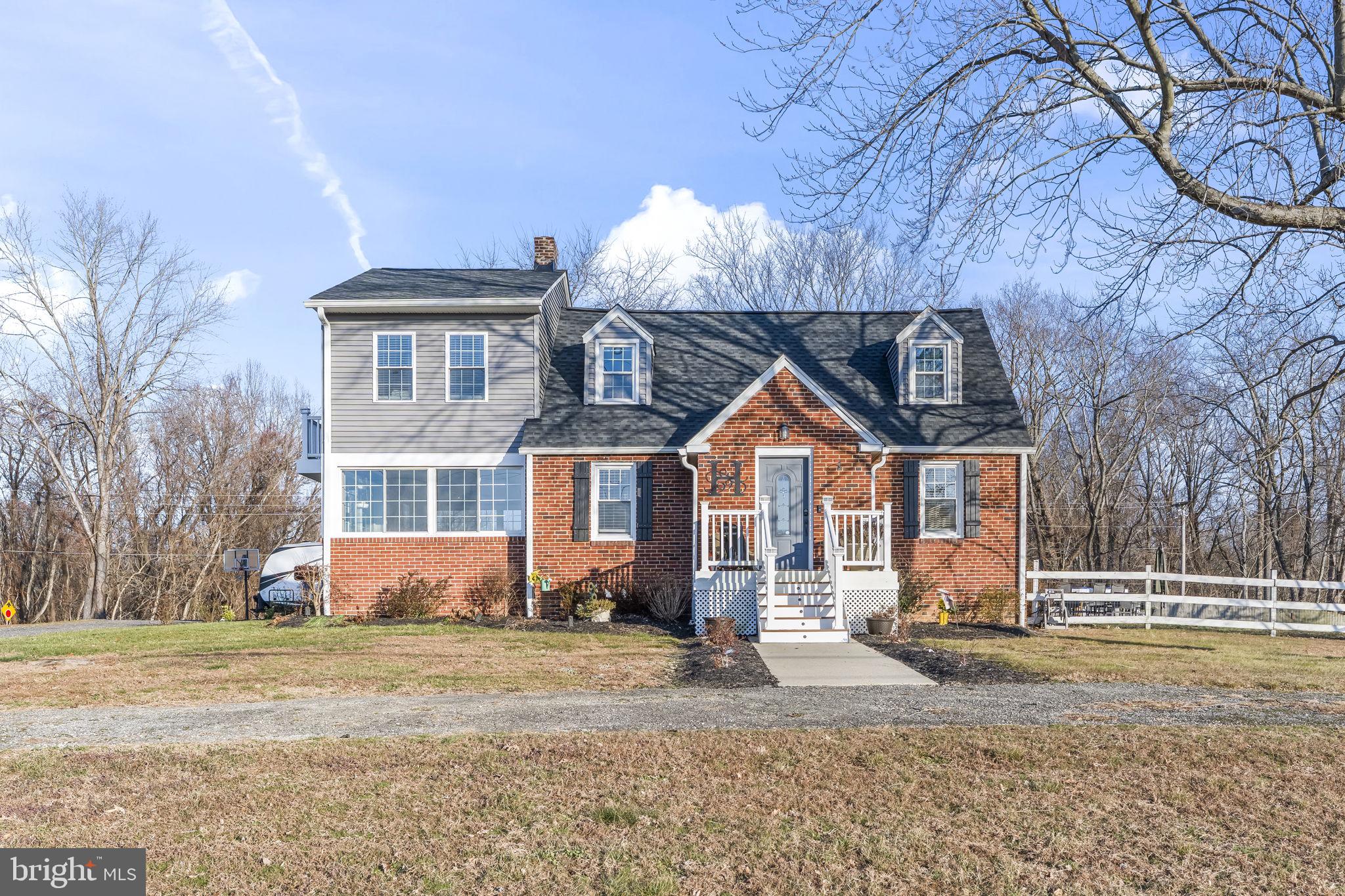 5920 Cherry Hill Road Huntingtown, MD 20639 - Photo 2 of 37 a front view of a house with garden