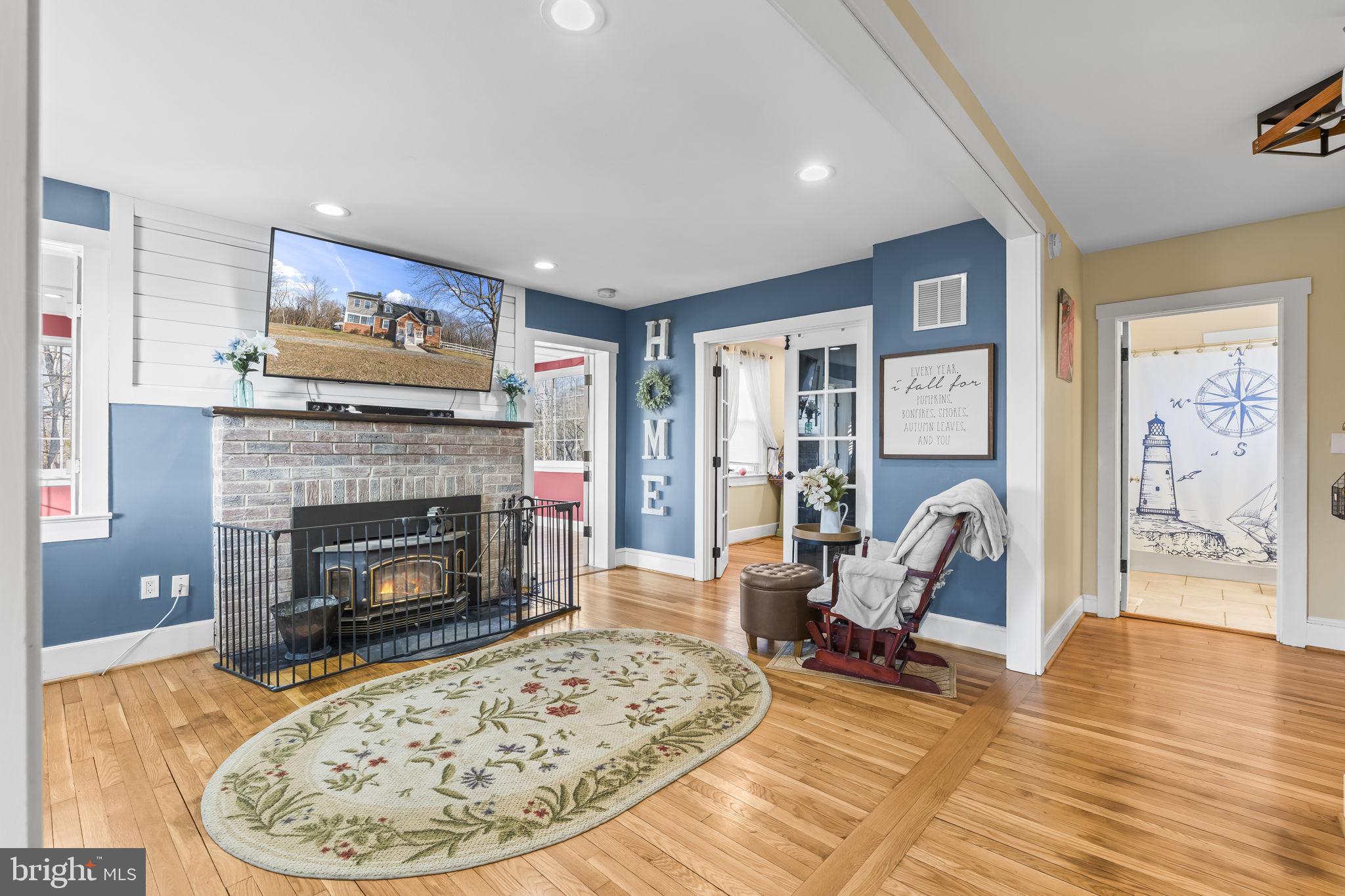 5920 Cherry Hill Road Huntingtown, MD 20639 - Photo 7 of 37 a living room with furniture and a fireplace