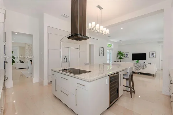 a kitchen with a table chairs sink and cabinets